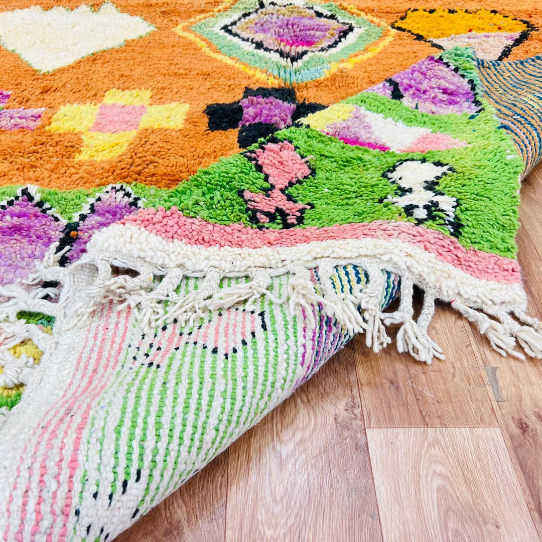Vintage Moroccan wool rug with orange base and colorful Berber geometric patterns, handmade in Morocco