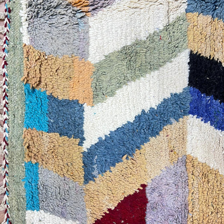 Vintage Moroccan wool rug 773 – colorful handmade Berber carpet with zigzag chevron patterns in blue, pink, yellow, and cream, 264 × 164 cm (8.66 × 5.38 ft).