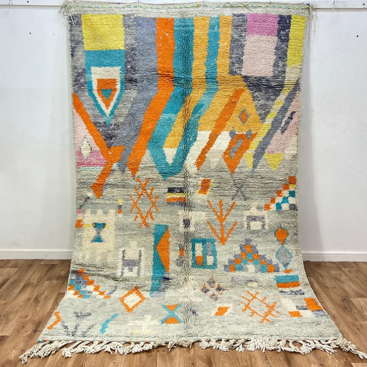 Vintage Moroccan wool rug 782 – cream and colorful handmade Berber carpet with geometric orange, turquoise, and grey patterns, 271 × 170 cm (8.89 × 5.57 ft).