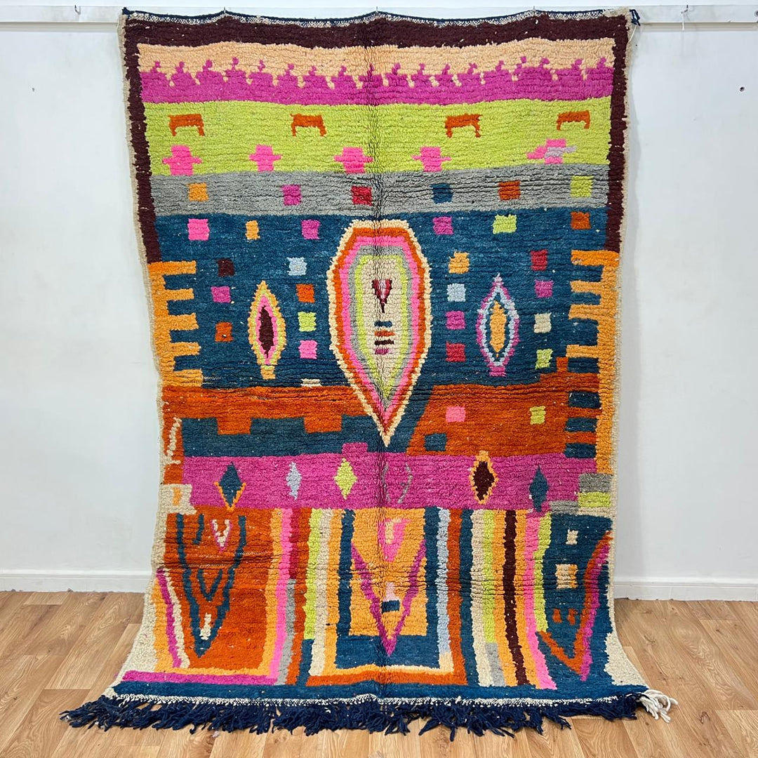 Vintage Moroccan wool rug 138 – handmade colorful geometric Berber design with pink, blue, and orange tones (234 × 162 cm).