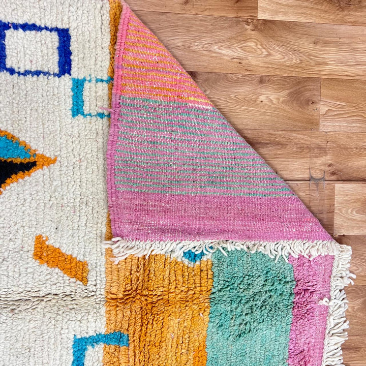 Vintage Moroccan wool rug 251 – handmade colorful geometric Berber rug with orange, turquoise, and yellow diamonds (252 × 150 cm).