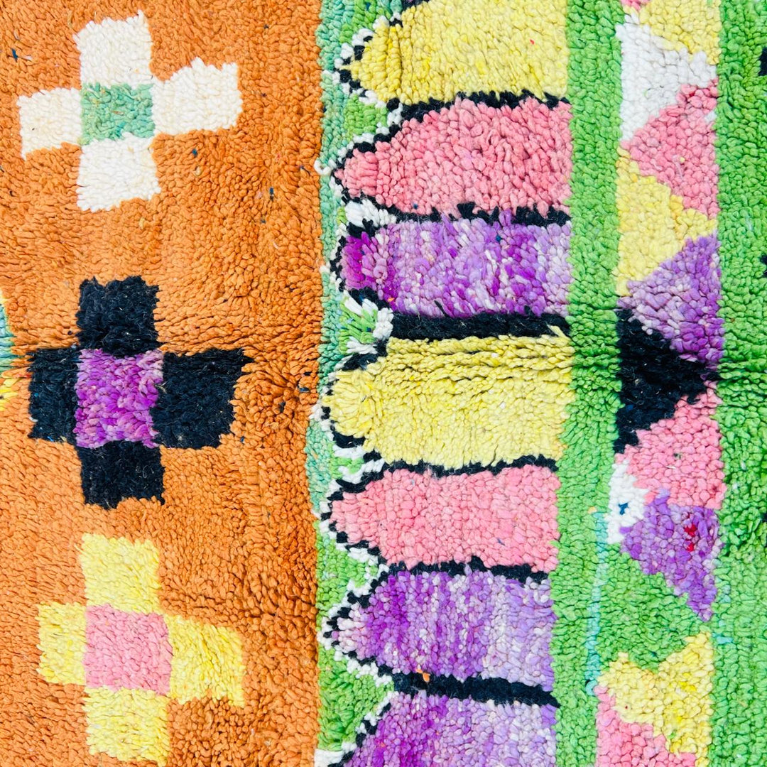 Vintage Moroccan wool rug with orange base and colorful Berber geometric patterns, handmade in Morocco