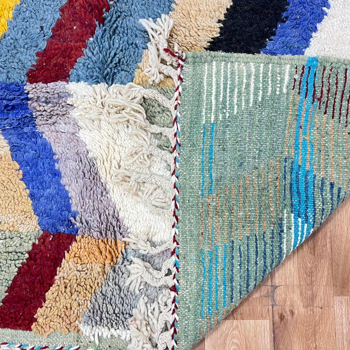 Vintage Moroccan wool rug 773 – colorful handmade Berber carpet with zigzag chevron patterns in blue, pink, yellow, and cream, 264 × 164 cm (8.66 × 5.38 ft).