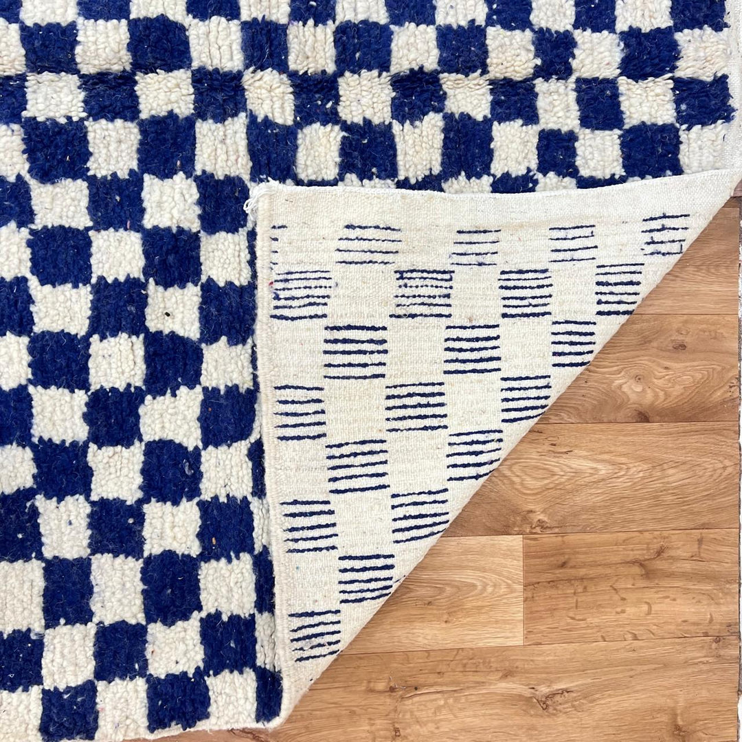Vintage Moroccan wool rug 142 – handmade blue and white checkered Berber rug (243 × 152 cm).