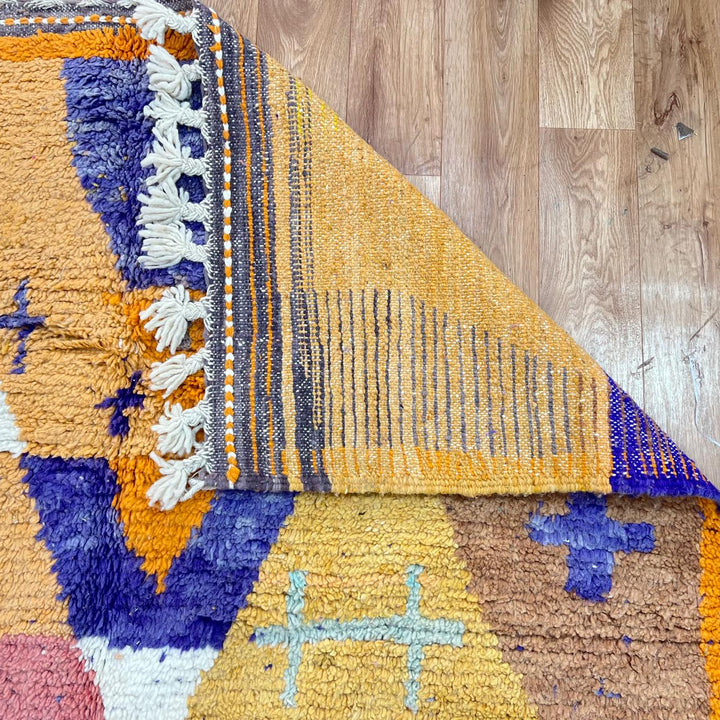 Vintage Moroccan wool rug 257 – handmade Berber rug with vibrant geometric design in orange, yellow, purple, and blue (264 × 162 cm).