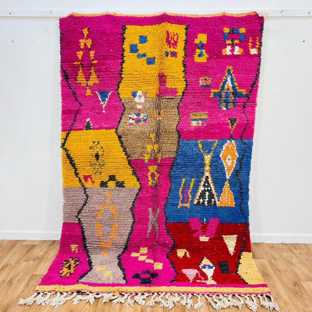 Vintage Moroccan rug with colorful Berber geometric patterns in pink, yellow, blue and red, handmade wool carpet from Morocco
