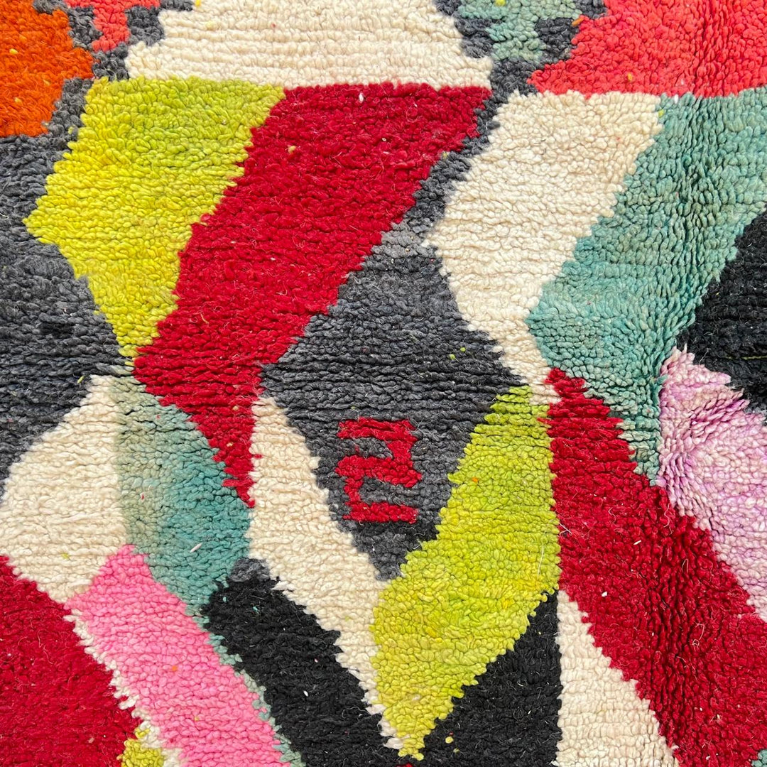 Vintage Moroccan wool rug 210 – handmade colorful geometric Berber design in red, green, pink, and cream (282 × 158 cm).