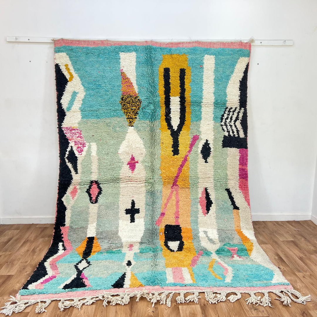 Vintage Moroccan wool rug 857 – handmade abstract Berber carpet in turquoise, black, pink, and mustard tones (290 × 205 cm / 9.51 × 6.72 ft).