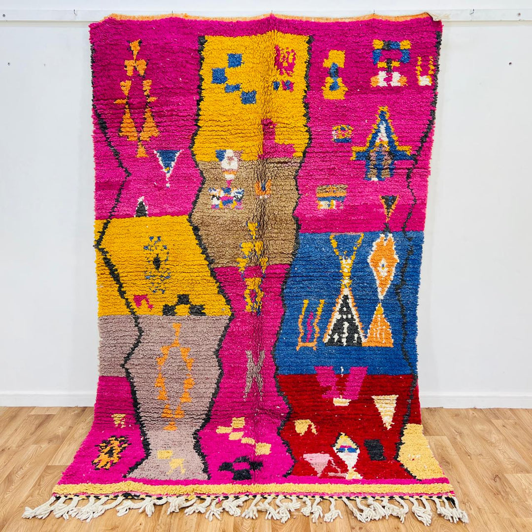 Vintage Moroccan rug with colorful Berber geometric patterns in pink, yellow, blue and red, handmade wool carpet from Morocco