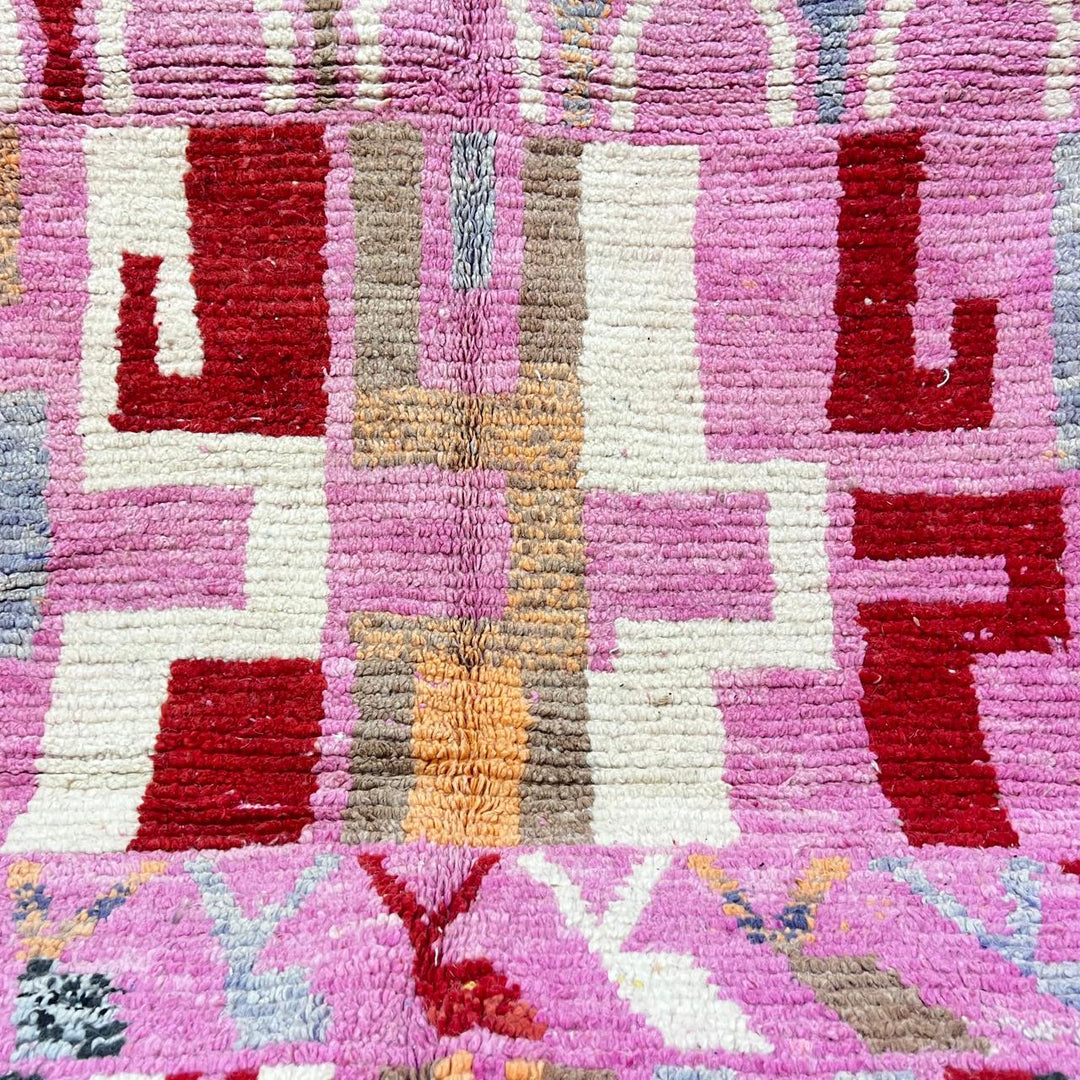 Vintage Moroccan wool rug 776 – colorful handmade Berber carpet with pink, red, and beige geometric patterns, 262 × 168 cm (8.59 × 5.51 ft).
