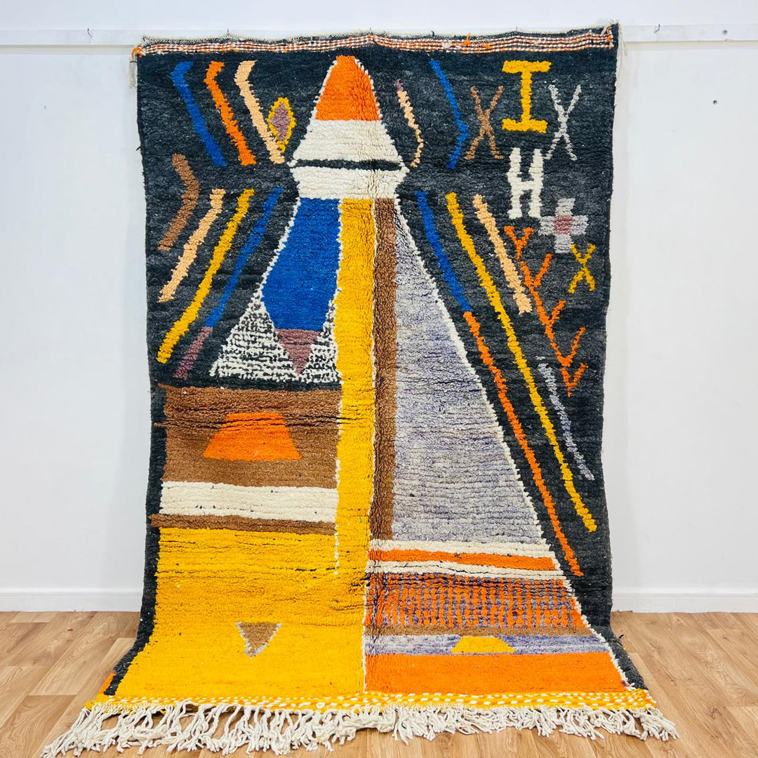 Vintage Moroccan wool rug with abstract geometric Berber design in mustard yellow, blue, and black, handmade in Morocco