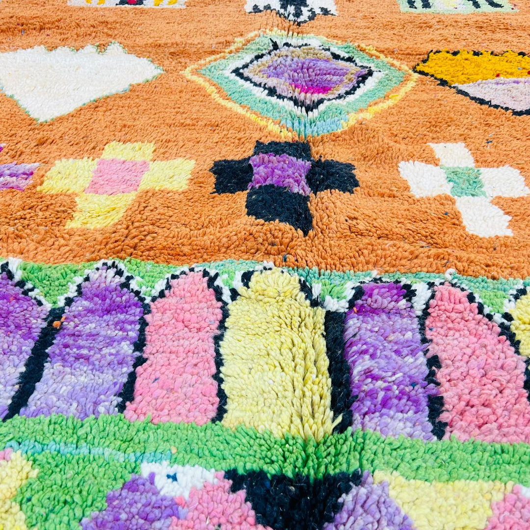 Vintage Moroccan wool rug with orange base and colorful Berber geometric patterns, handmade in Morocco