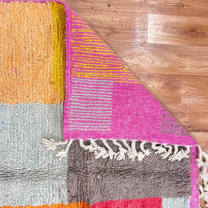 Vintage Moroccan Wool Rug 233 – handmade geometric Berber rug in orange, pink and yellow tones (254 × 154 cm).