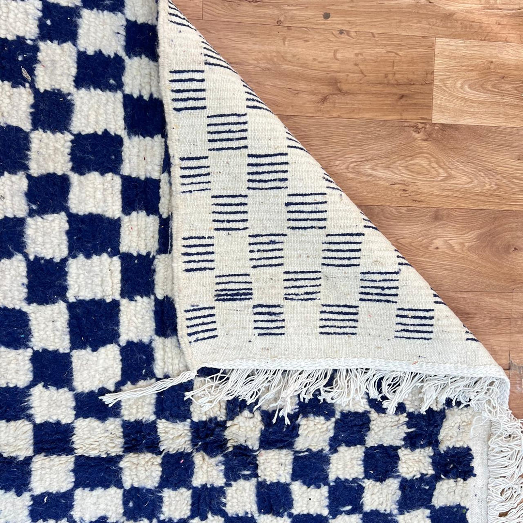 Vintage Moroccan wool rug 142 – handmade blue and white checkered Berber rug (243 × 152 cm).