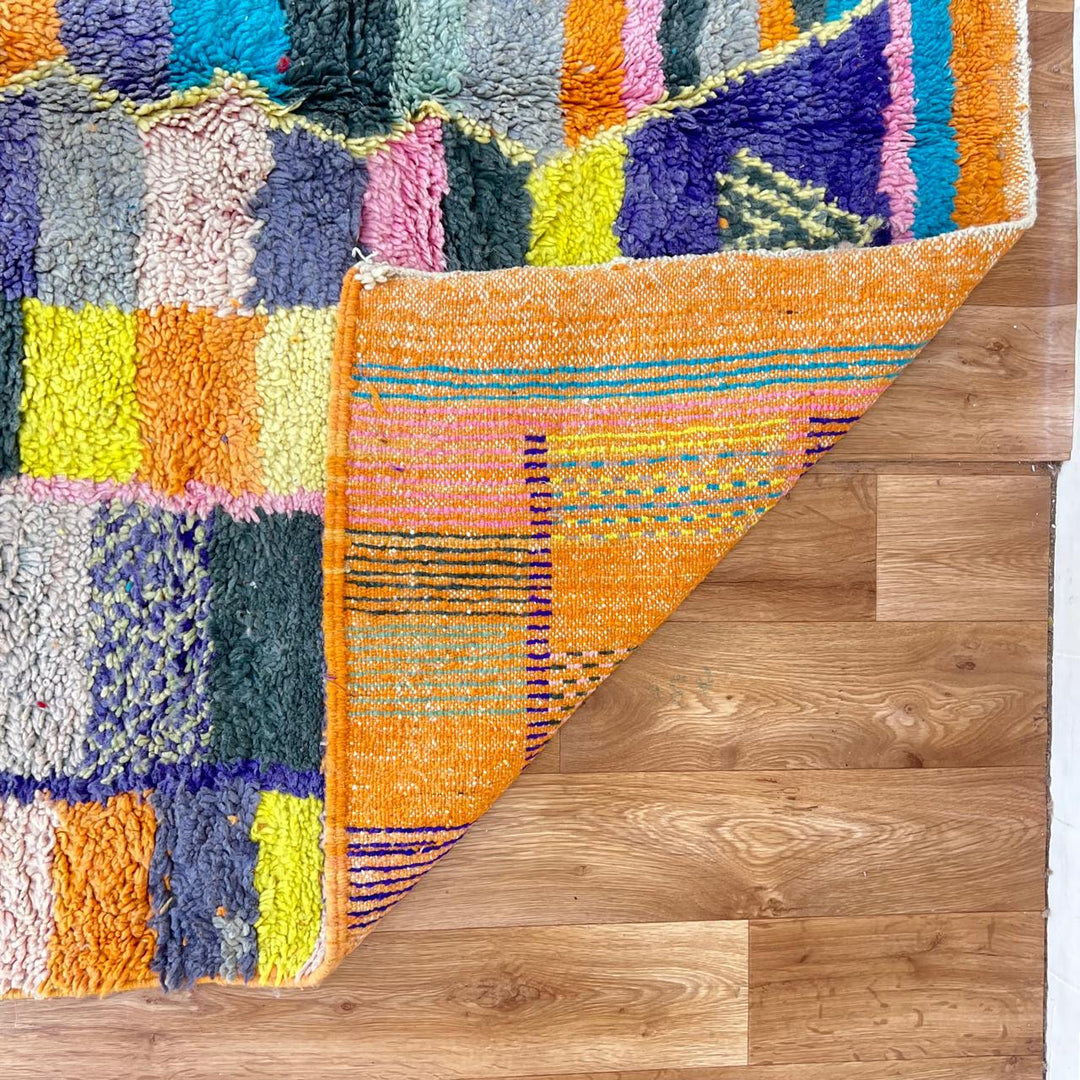 Vintage Moroccan wool rug with colorful geometric mosaic Berber pattern in mustard, orange, teal, pink and blue, handwoven in Morocco
