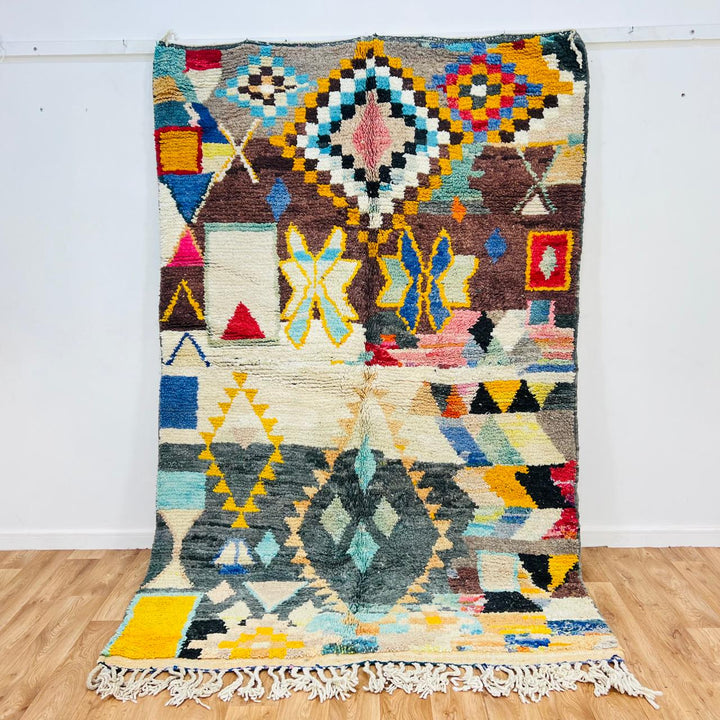 Vintage Moroccan Berber wool rug with colorful geometric tribal patterns in beige, grey, yellow and blue, handmade in Morocco, 256x165 cm