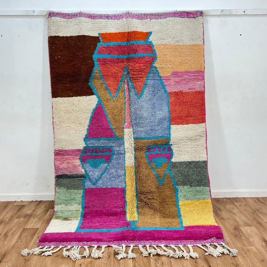 Vintage Moroccan wool rug with abstract Berber figure in turquoise and warm pink, sand and brown tones, handwoven in Morocco
