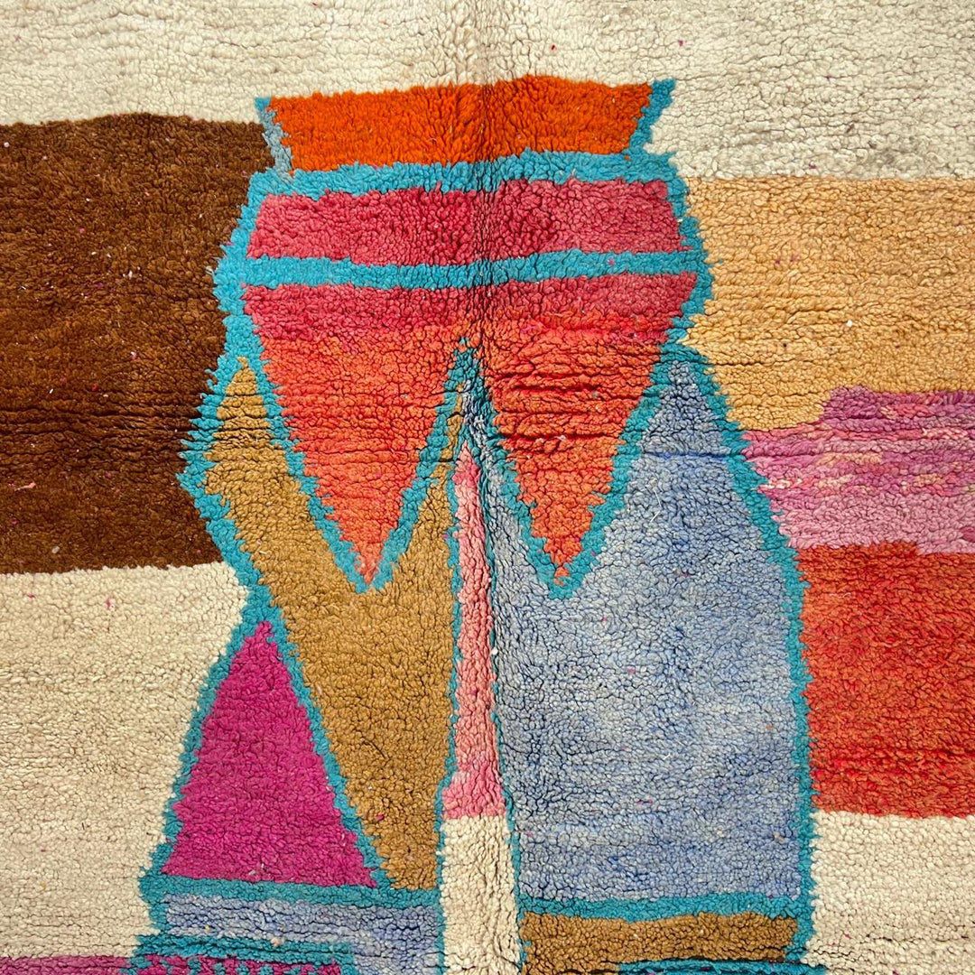 Vintage Moroccan wool rug with abstract Berber figure in turquoise and warm pink, sand and brown tones, handwoven in Morocco