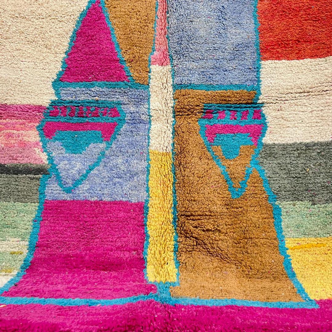 Vintage Moroccan wool rug with abstract Berber figure in turquoise and warm pink, sand and brown tones, handwoven in Morocco