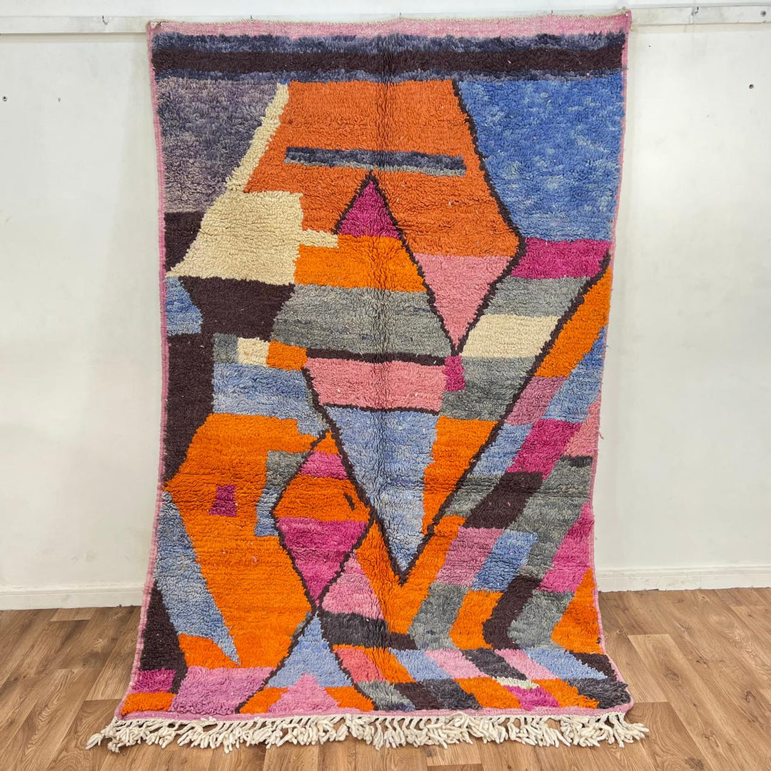 Vintage Moroccan wool rug with abstract geometric Berber design in orange, pink, blue and gray tones, handwoven in Morocco.