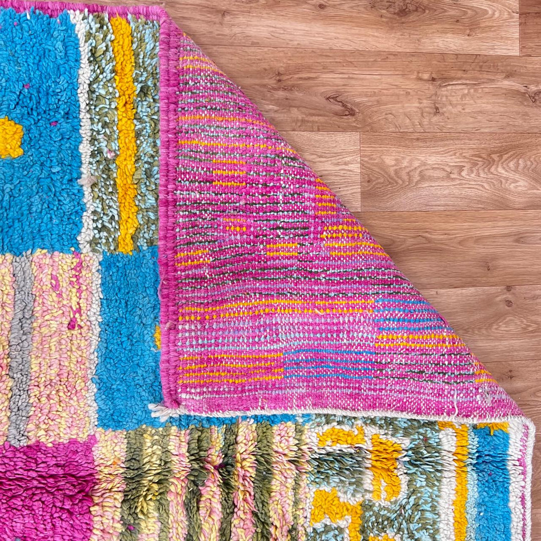 Vintage Moroccan wool rug with colorful Berber cross pattern in teal, yellow, pink and ivory, handwoven in Morocco