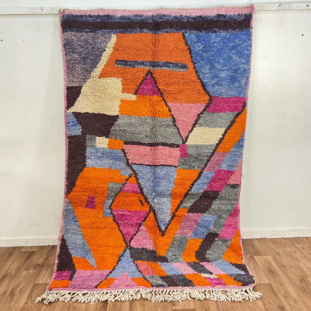 Vintage Moroccan wool rug with abstract geometric Berber design in orange, pink, blue and gray tones, handwoven in Morocco.