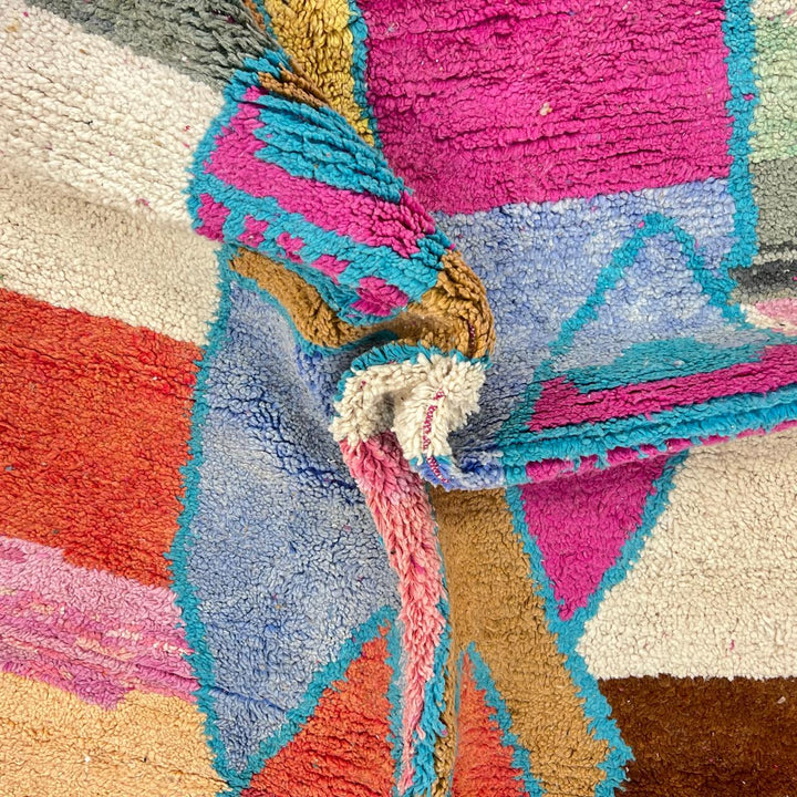 Vintage Moroccan wool rug with abstract Berber figure in turquoise and warm pink, sand and brown tones, handwoven in Morocco