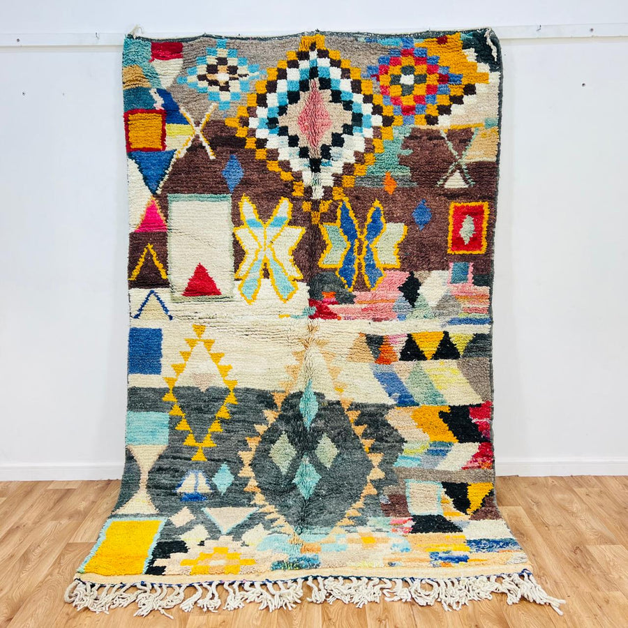 Vintage Moroccan Berber wool rug with colorful geometric tribal patterns in beige, grey, yellow and blue, handmade in Morocco, 256x165 cm