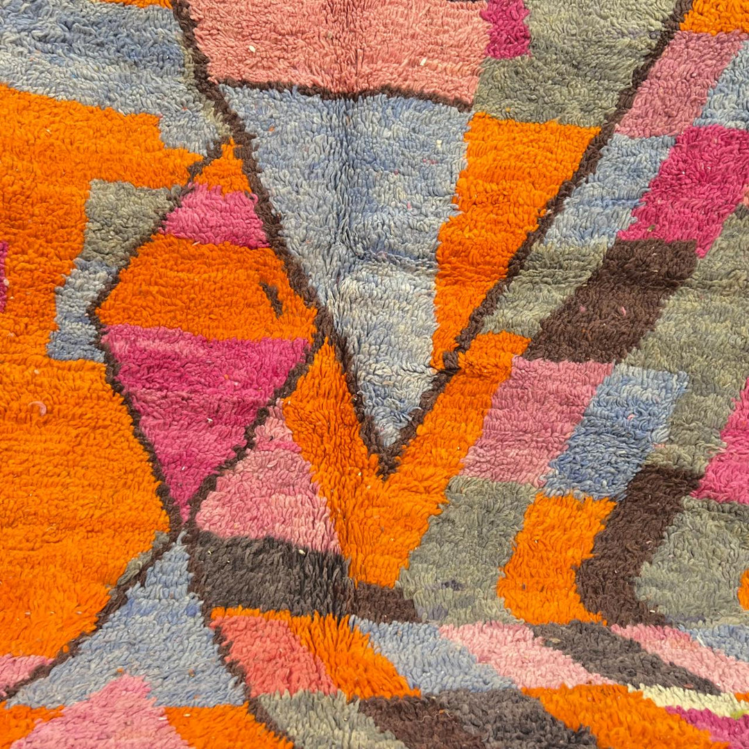 Vintage Moroccan wool rug with abstract geometric Berber design in orange, pink, blue and gray tones, handwoven in Morocco.