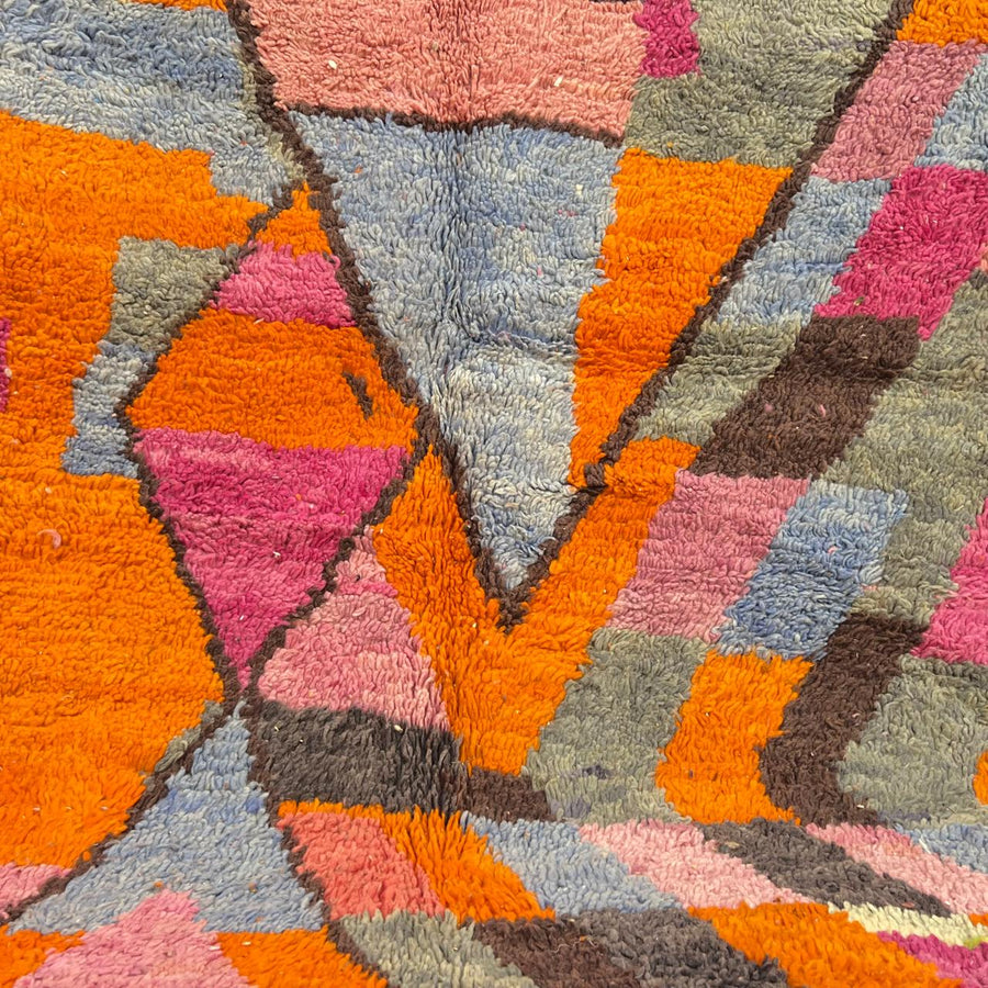 Vintage Moroccan wool rug with abstract geometric Berber design in orange, pink, blue and gray tones, handwoven in Morocco.