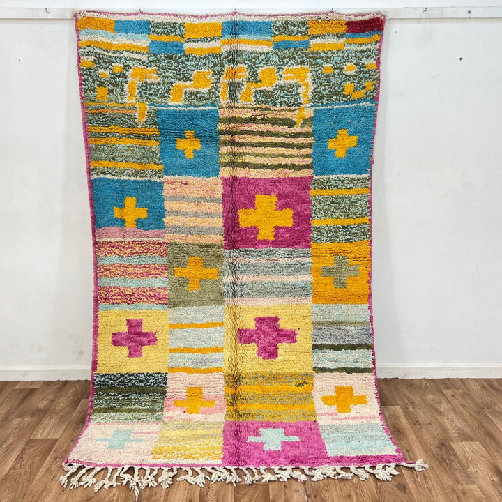 Vintage Moroccan wool rug with colorful Berber cross pattern in teal, yellow, pink and ivory, handwoven in Morocco