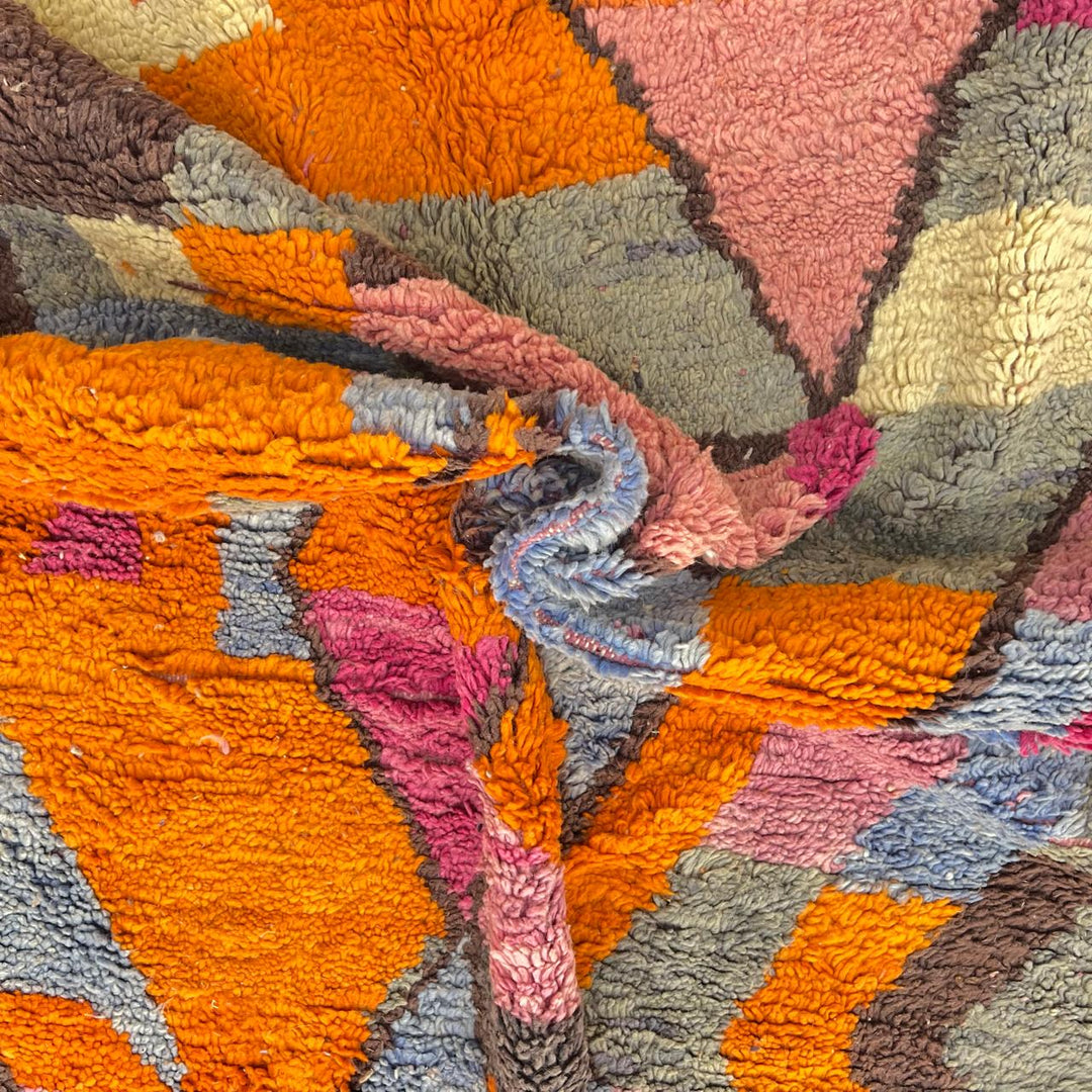 Vintage Moroccan wool rug with abstract geometric Berber design in orange, pink, blue and gray tones, handwoven in Morocco.