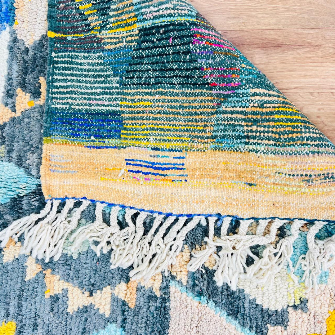 Vintage Moroccan Berber wool rug with colorful geometric tribal patterns in beige, grey, yellow and blue, handmade in Morocco, 256x165 cm