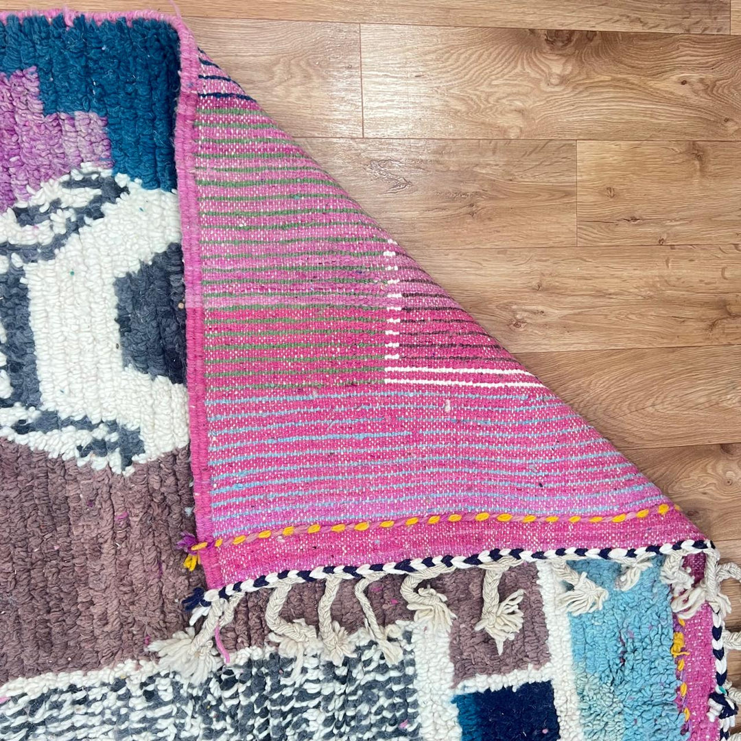 Vintage Moroccan wool rug with abstract Berber geometric motifs in mustard yellow, blue, lilac and ivory, handwoven in Morocco
