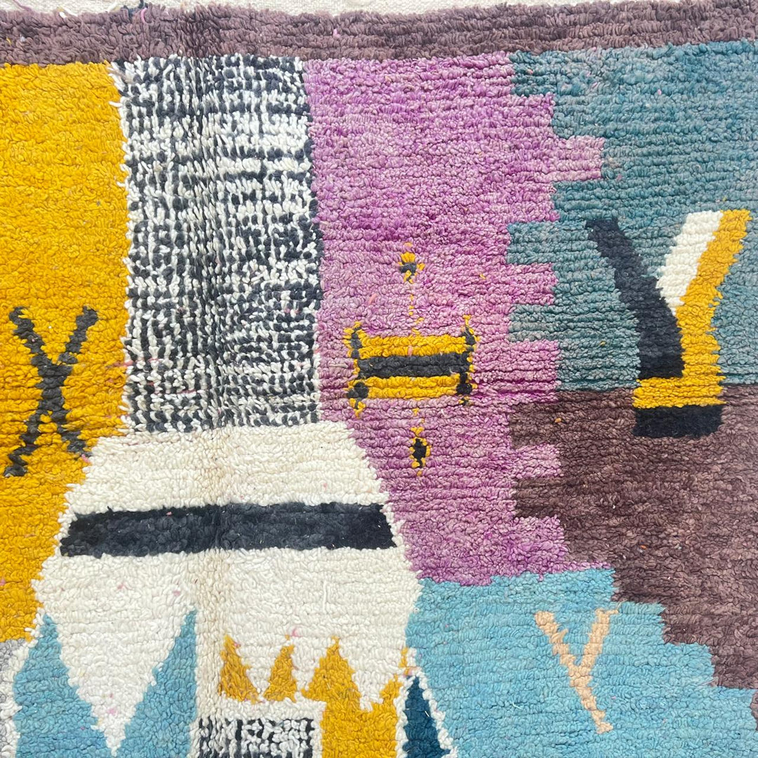 Vintage Moroccan wool rug with abstract Berber geometric motifs in mustard yellow, blue, lilac and ivory, handwoven in Morocco