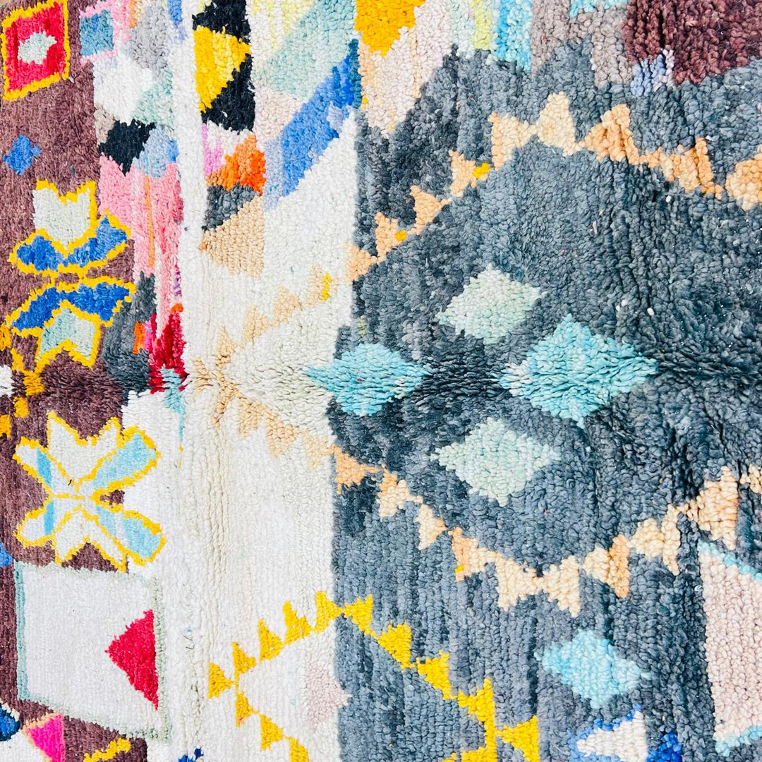 Vintage Moroccan Berber wool rug with colorful geometric tribal patterns in beige, grey, yellow and blue, handmade in Morocco, 256x165 cm